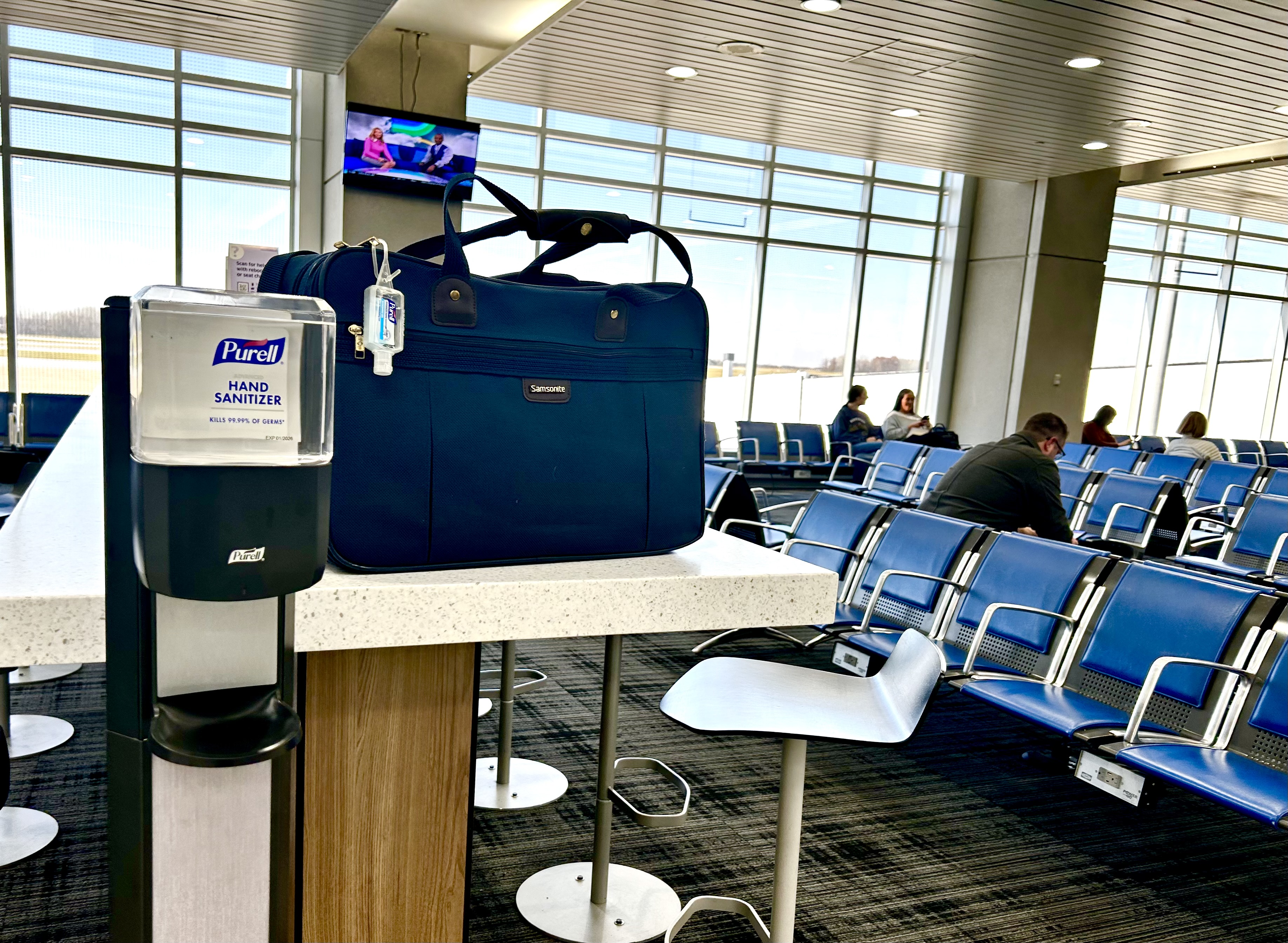 A PURELL ES8 dispenser is available for travelers to sanitize hands while they're at the gate of an airport.